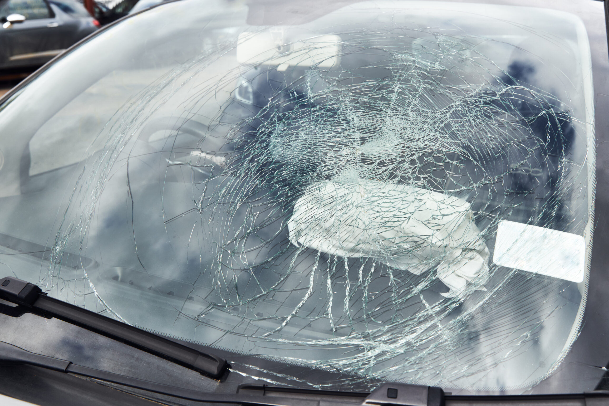 Severely cracked windshield on a vehicle requiring replacement in Red Deer